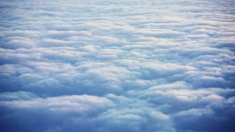 Beautiful sunset sky above clouds with dramatic light. Cabin view from airpla Stock Footage 246673044