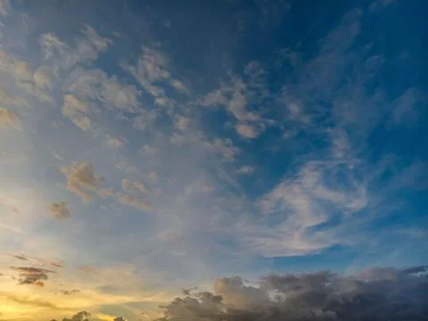 Beautiful sunset sky with dramatic blue and orange clouds at dusk. Stock Photos