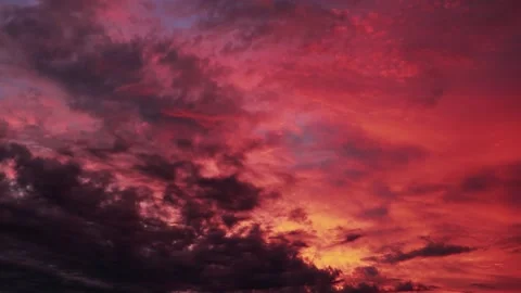 Beautiful sunset sky. Movement of pink clouds in rays of the evening sun. Summer Stock Footage 157787706