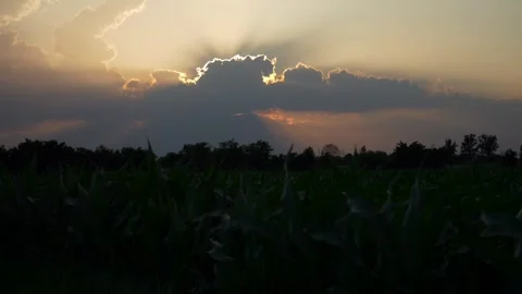 Beautiful sunset with sun rays coming out behind the clouds. Slow motion 4K Stock Footage 277417793