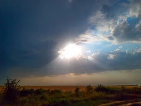 Beautiful sunset, sun rays through clouds. Stock Photos