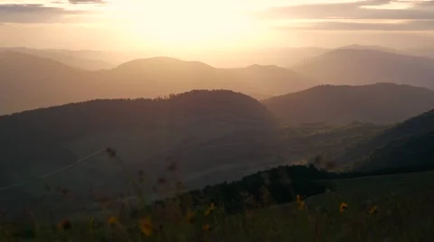 Beautiful sunset through the many layers of clouds. Sunset over the mountains Stock Footage 59946095