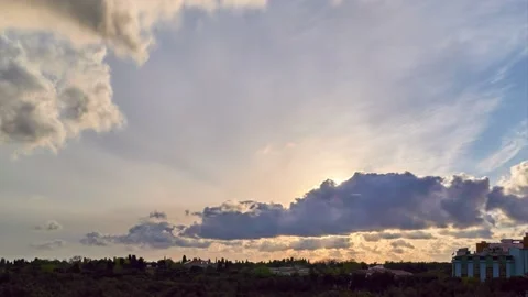 Beautiful sunset time lapse with clouds, trees and buildings Stock Footage 131260350