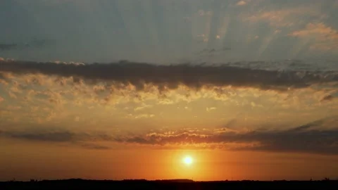 Beautiful Sunset Time lapse with Clouds over the Field. The Sun Sets on the Hori Stock Footage 135574122