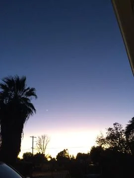 A beautiful sunset with a tree in the background Stock Photos