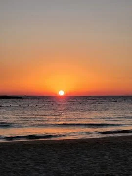 Beautiful sunset on the tropic beach. The sun goes down. Stock Photos