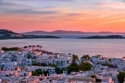 Beautiful sunset view of famous white windmills on hill top, Mykonos, Greece Stock Photos