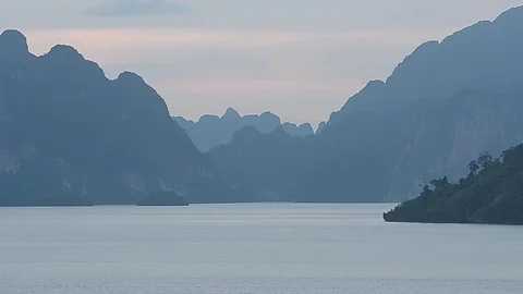 Beautiful sunset view of mountain and lake inside Ratchapprapha Dam. Stock Footage 104035826