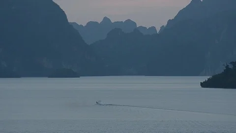 Beautiful sunset view of mountain and lake inside Ratchapprapha Dam. Stock Footage 104035970