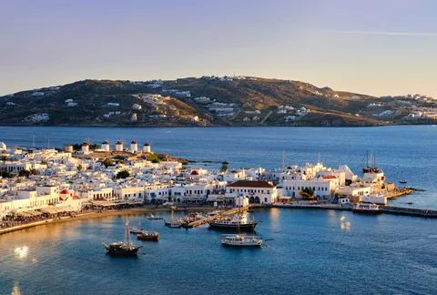 Beautiful sunset view over Mykonos, Cyclades, Greece, harbor and port. Golden Stock Photos