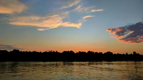 Beautiful sunset view on the river with lots of tree shadows. 4K Video stock 287704764