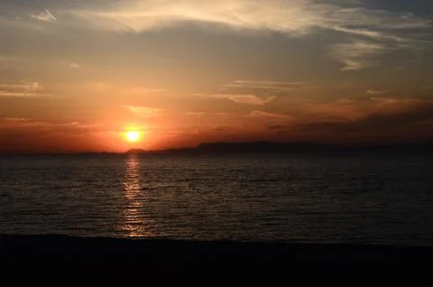 Beautiful sunset when sun is going to hide in Rhodes Stock Photos