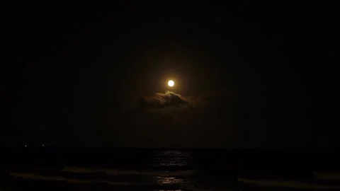 Beautiful supermoon with clouds reflecting off rippling Mediterranean Sea Stock Footage 266837889