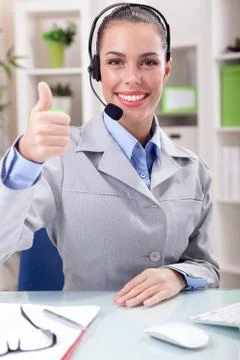Beautiful Support phone operator in headset at workplace Stock Photos