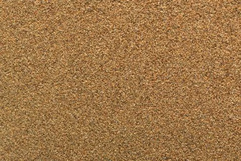 Beautiful surface texture of wet beach sand in brown color Stock Photos
