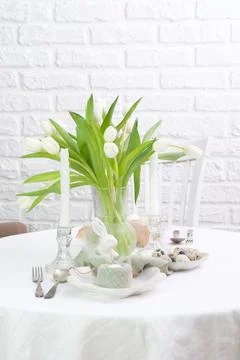 Beautiful table serving for Easter celebration in dining room, plates with Stock Photos