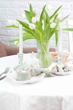 Beautiful table serving for Easter celebration in dining room, plates with Stock Photos