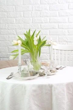 Beautiful table serving for Easter celebration in dining room, plates with Stock Photos