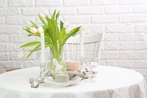 Beautiful table serving for Easter celebration in dining room, plates with Stock Photos