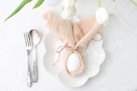 Beautiful table serving for Easter celebration in dining room, plates with Stock Photos