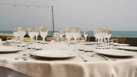 Beautiful table set up for an elegant wedding with candles and flowers by the s 库存影片 223962505