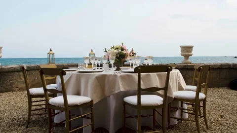 Beautiful table set up for an elegant wedding with candles and flowers by the se Video stock 223963922