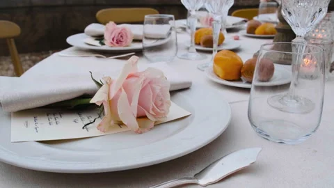 Beautiful table set up for an elegant wedding with candles and flowers by the se Video stock 223965039