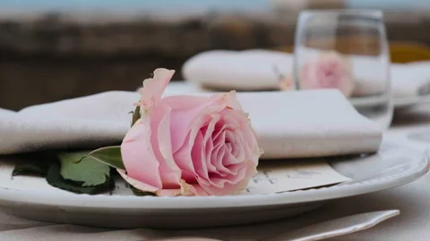 Beautiful table set up for an elegant wedding with candles and flowers by the se Video stock 223965184