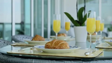 Beautiful table set with servings of freshly baked croissants on ceramic plates Video stock 242941919