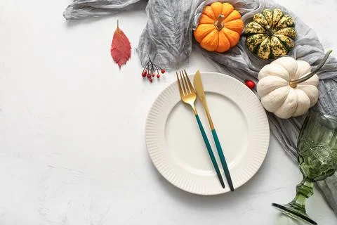 Beautiful table setting with berries, pumpkins autumn leaf on white backgroun Stock Photos
