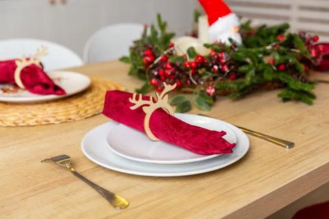 Beautiful table setting with Christmas decor in living room. Фото