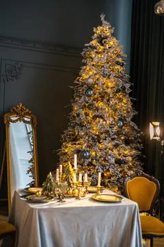 Beautiful table setting with Christmas decorations in living room Stock Photos