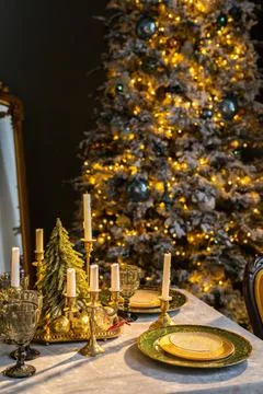 Beautiful table setting with Christmas decorations in living room Stock Photos