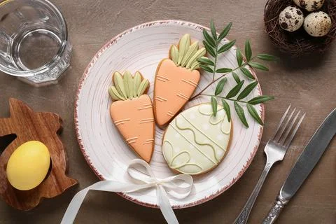 Beautiful table setting with different Easter cookies and eggs on brown grung Stock Photos