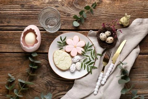 Beautiful table setting with different Easter cookies, eggs and eucalyptus br Stock Photos