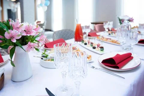 Beautiful table setting with dishes and flowers for a party, birthday, reception Stock Photos