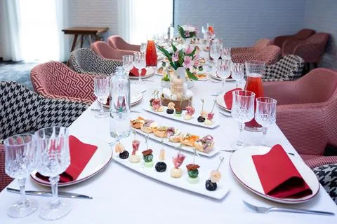 Beautiful table setting with dishes and flowers for a party, birthday, reception Stock Photos