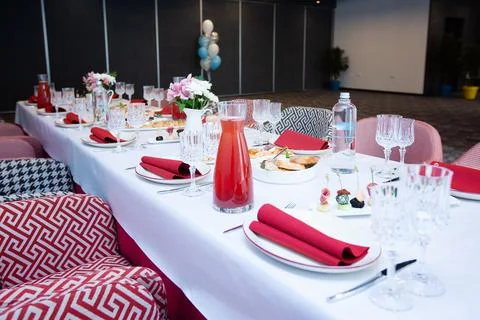 Beautiful table setting with dishes and flowers for a party, birthday, reception Stock Photos
