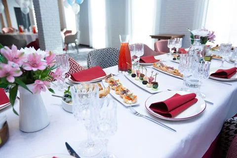 Beautiful table setting with dishes and flowers for a party, birthday, reception Stock Photos