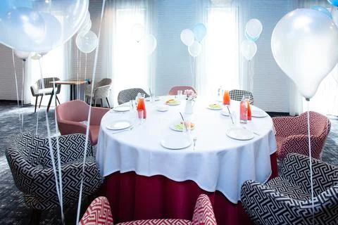 Beautiful table setting with dishes and flowers for a party, birthday, reception Stock Photos