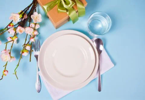 Beautiful table setting for Easter day decorated cherry blossom branch. Stock Photos