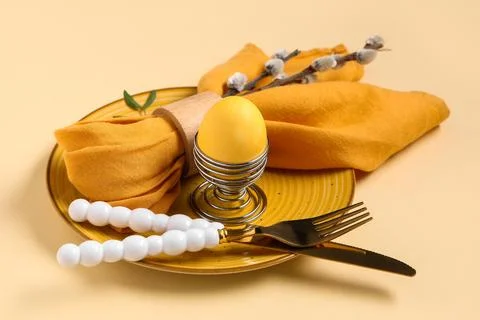 Beautiful table setting with Easter egg and pussy willow branches on yellow b Stock Photos