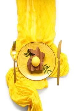 Beautiful table setting with Easter egg and leaves on white background Stock Photos
