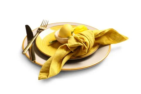 Beautiful table setting with Easter egg and yellow tulip flower on white back Stock Photos
