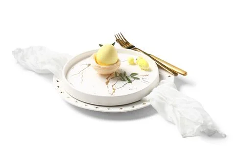Beautiful table setting with Easter eggs and leaves on white background Stock Photos