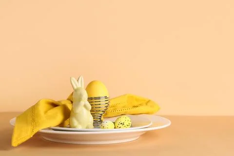 Beautiful table setting with folded napkin, painted eggs and Easter bunny on  Stock Photos