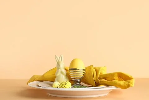 Beautiful table setting with folded napkin, painted eggs and Easter bunny on  Stock Photos