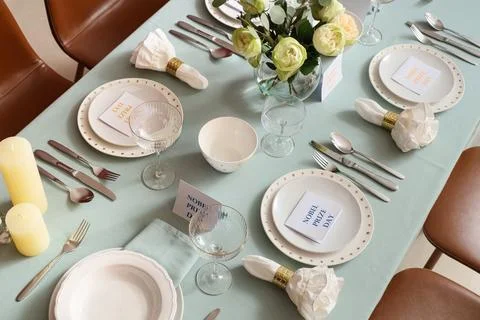 Beautiful table setting for Nobel prize day with flowers and candles in dinin Stock Photos