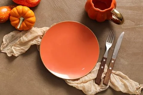 Beautiful table setting with pumpkins on brown background Stock Photos