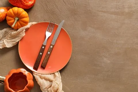 Beautiful table setting with pumpkins on brown background Stock Photos